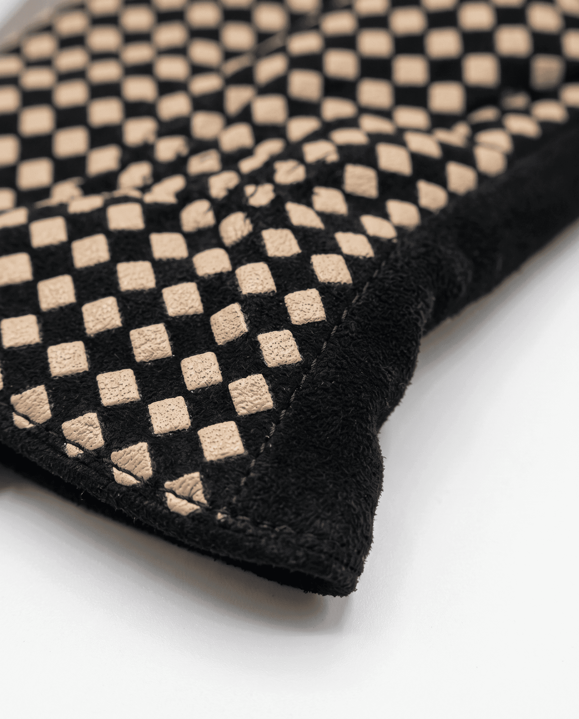 black suede gloves with a cream checkerboard back, detail