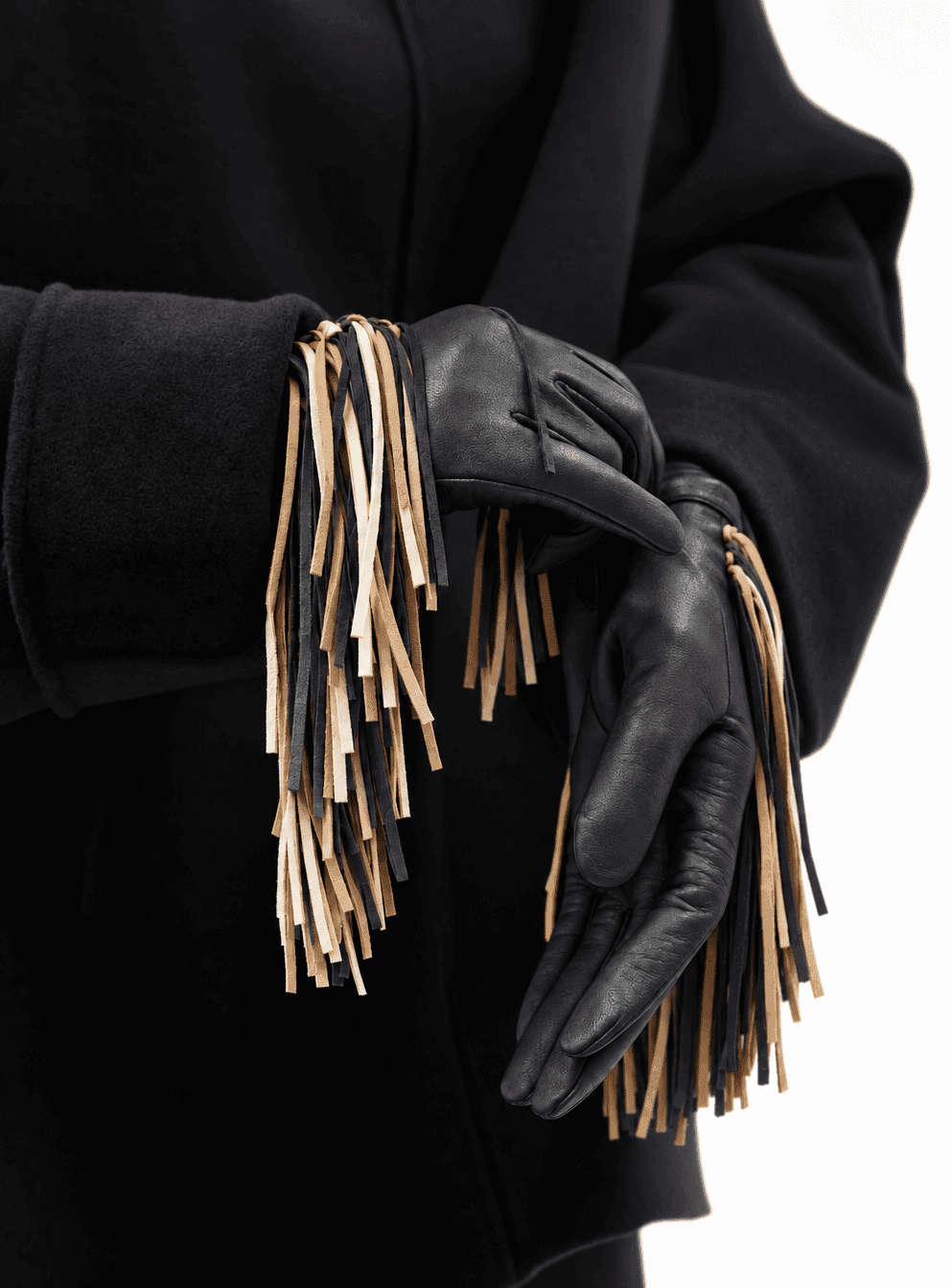 black nappa leather gloves with a black, tan and cream fringe, worn